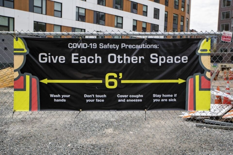 image of a social distancing sign at a construction site