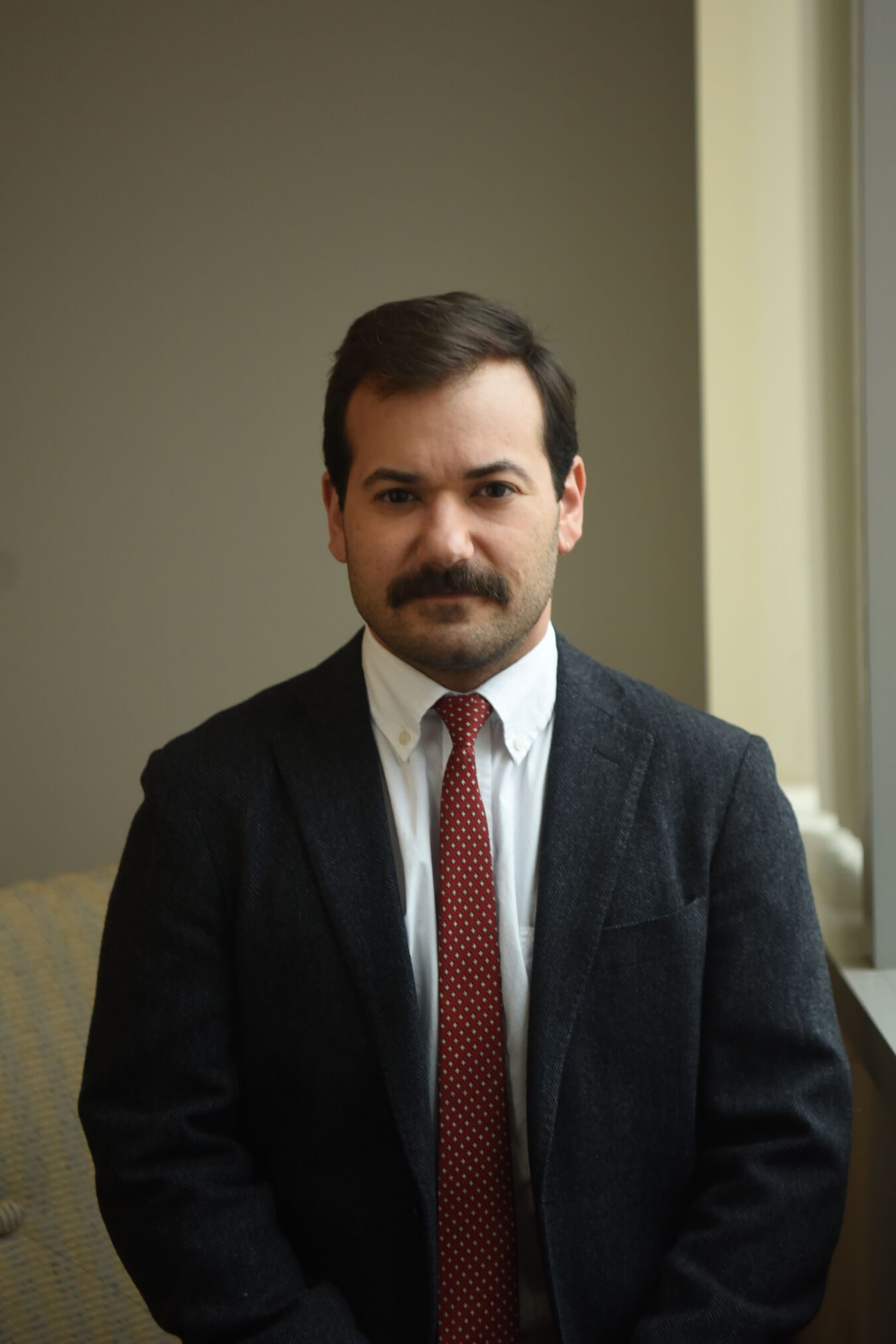 Headshot of Attorney Gabriel Fonseca. A man with dark hair and a moustache wearing a suit and tie.